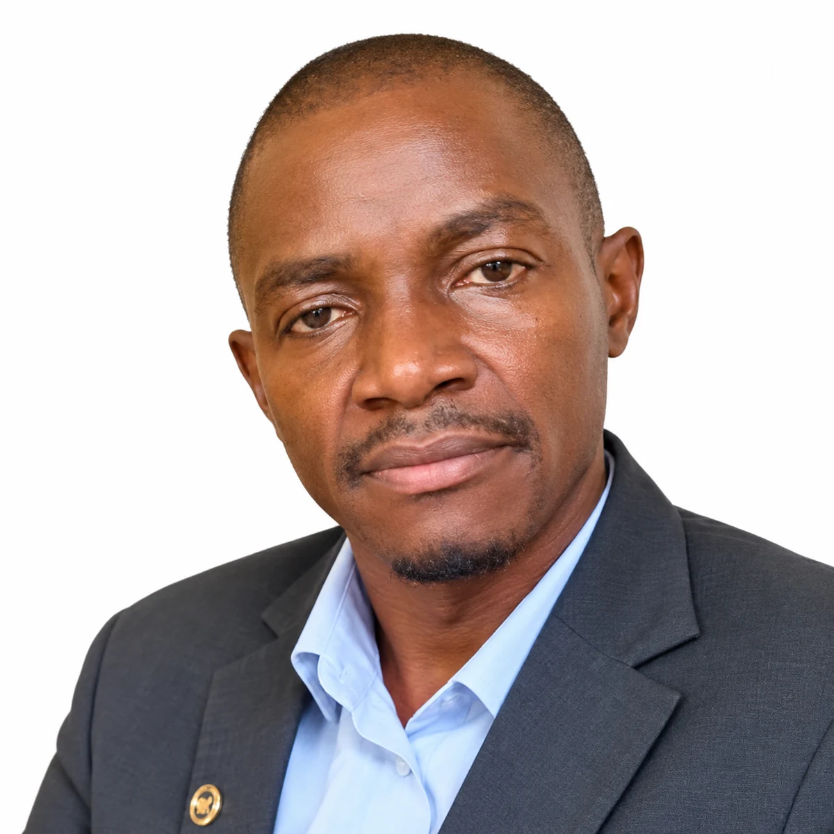 Portrait of Hon. Clarence Namunyu Kasali in a dark blazer and light blue shirt